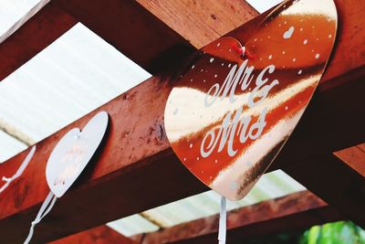 High angle view of heart shape hanging on wood