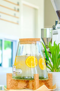 Close-up of drink in container with faucet