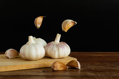 Close-up of pumpkins on table against black background