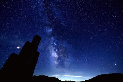 Low angle view of silhouette stars against sky at night