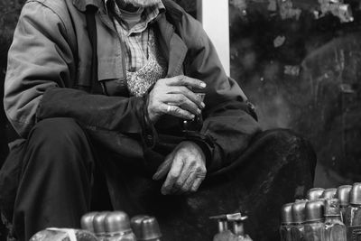 Midsection of man holding turkish teacup at market stall