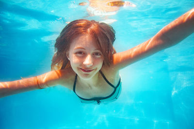 Young woman swimming in sea