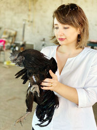 Young woman looking at bird