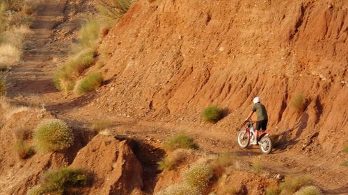 Man riding motorcycle on rock