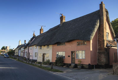 A row of thatched cottages in the village of haughley, suffolk, uk