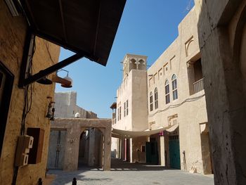 Low angle view of buildings in town against sky