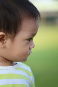 Close-up of cute boy looking away outdoors