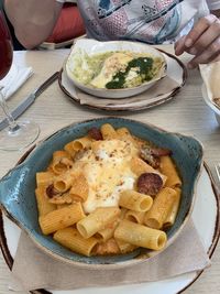 Close-up of hand holding ice cream in plate