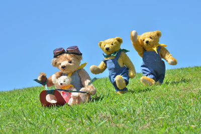 High angle view of toys on field against blue sky