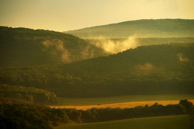 Scenic view of field against sky during sunset