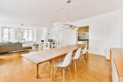 Empty chairs and tables and table and chair and woman sitting on floor at home