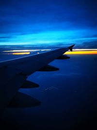 Airplane wing against blue sky