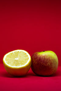 Close-up of fruits against orange background