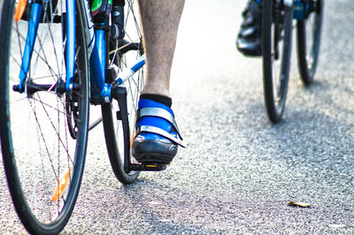 Low section of man riding bicycle on street