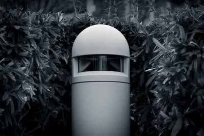 Close-up of bollard lighting equipment against plants in park