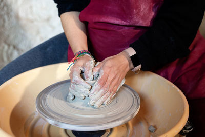 Ceramist artist female working in her atelier with the pottery wheel