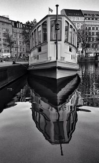 Boats in river with buildings in background