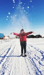 Full length of girl standing on snow covered land