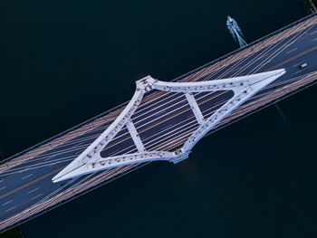 Low angle view of suspension bridge against sky at night