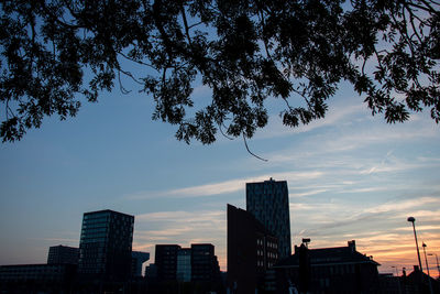 Low angle view of buildings against sky during sunset