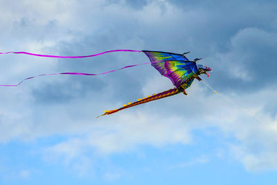 Low angle view of kite flying against sky