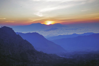 Scenic view of mountains against sky during sunset