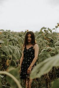 Young woman standing at sunflower farm