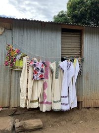 Clothes drying against wall outside house