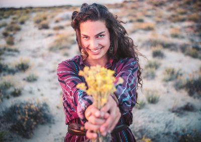 Portrait of smiling young woman holding bouquet