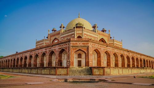 Facade of historic building against clear sky