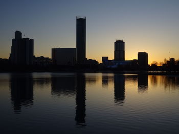 Scenic view of silhouette buildings against sky during sunset