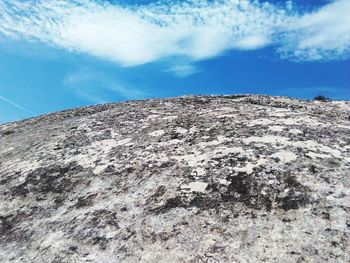 Low angle view of landscape against blue sky