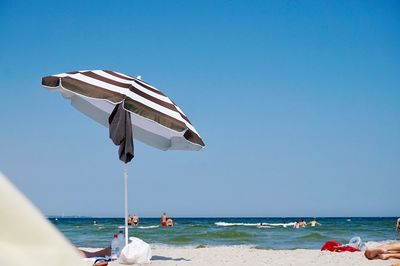 Scenic view of beach against clear sky