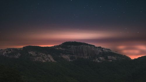 Scenic view of mountains against sky at dusk