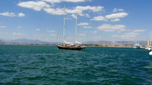 Boat sailing in sea against sky