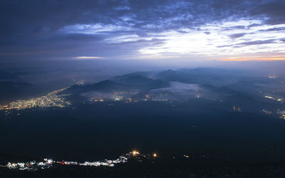 Aerial view of illuminated city against sky at night