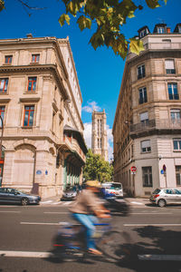City street by buildings against sky