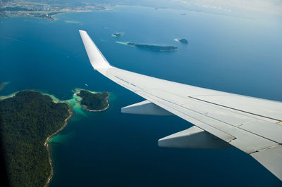 Close-up of airplane flying over sea