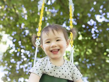 Portrait of smiling girl against plants