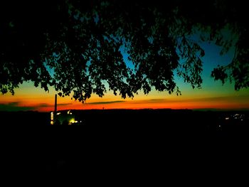 Silhouette trees against sky during sunset