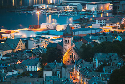 High angle view of illuminated buildings in city at night