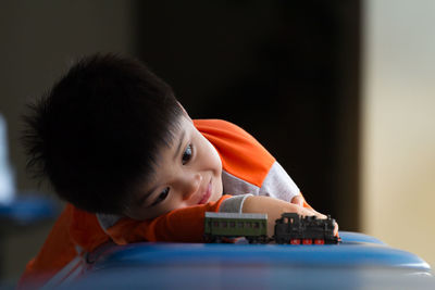 Boy playing with toy at home