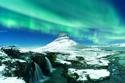 Scenic view of snowcapped mountains against sky during winter