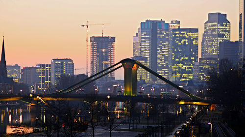 Illuminated buildings against sky in city