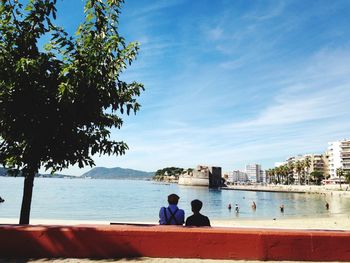 View of people overlooking calm sea