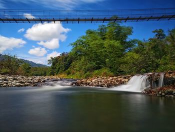 Scenic view of waterfall against sky