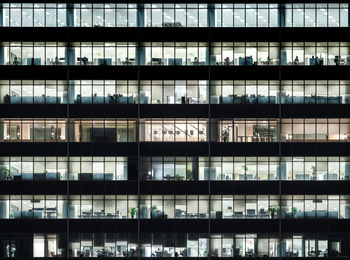 Close-up shot of illuminated office building at night