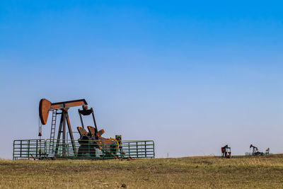 Machinery on land against sky