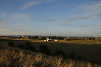 View of town against cloudy sky