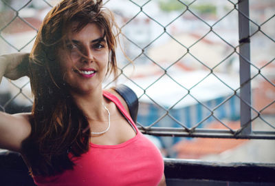Close-up of smiling young woman against blurred background